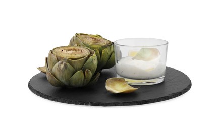 Photo of Delicious cooked artichokes with tasty sauce isolated on white