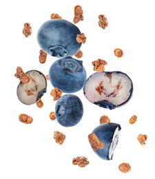 Image of Delicious granola and blueberries falling on white background. Healthy snack  