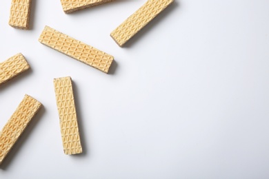 Flat lay composition with delicious crispy wafers on white background. Space for text