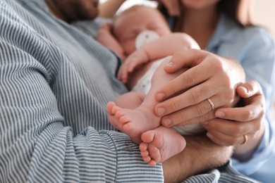 Photo of Happy couple with their newborn baby, closeup
