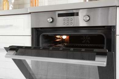 Open modern oven built in kitchen furniture, closeup
