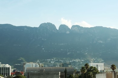 Picturesque view of mountains and city with skyscrapers