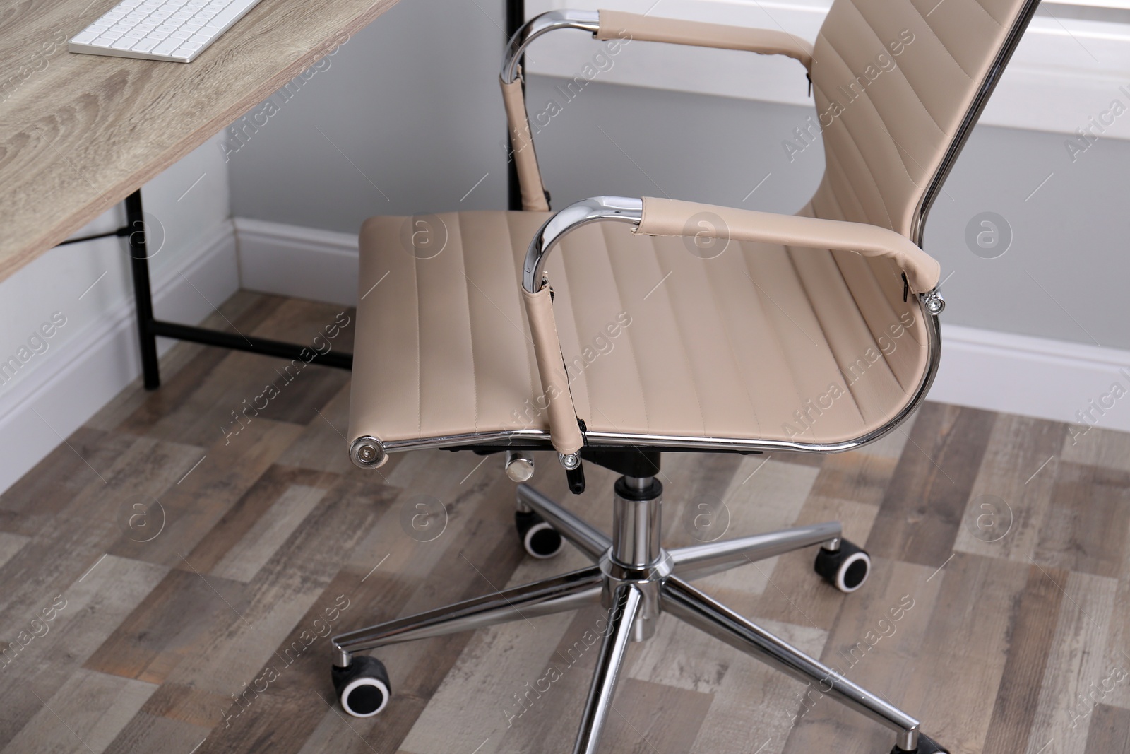 Photo of Comfortable office chair near table in room