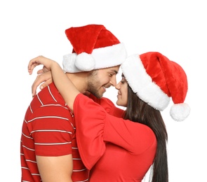 Photo of Young happy couple with Santa hats on white background. Christmas celebration