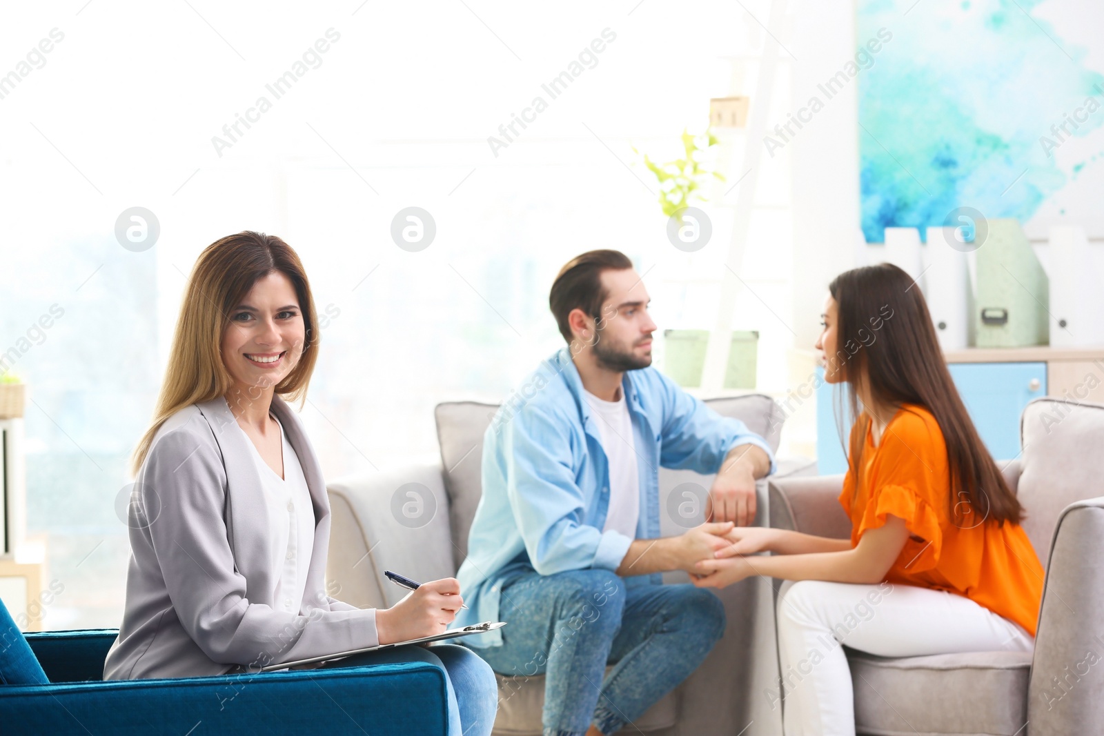 Photo of Professional psychologist and young couple in office