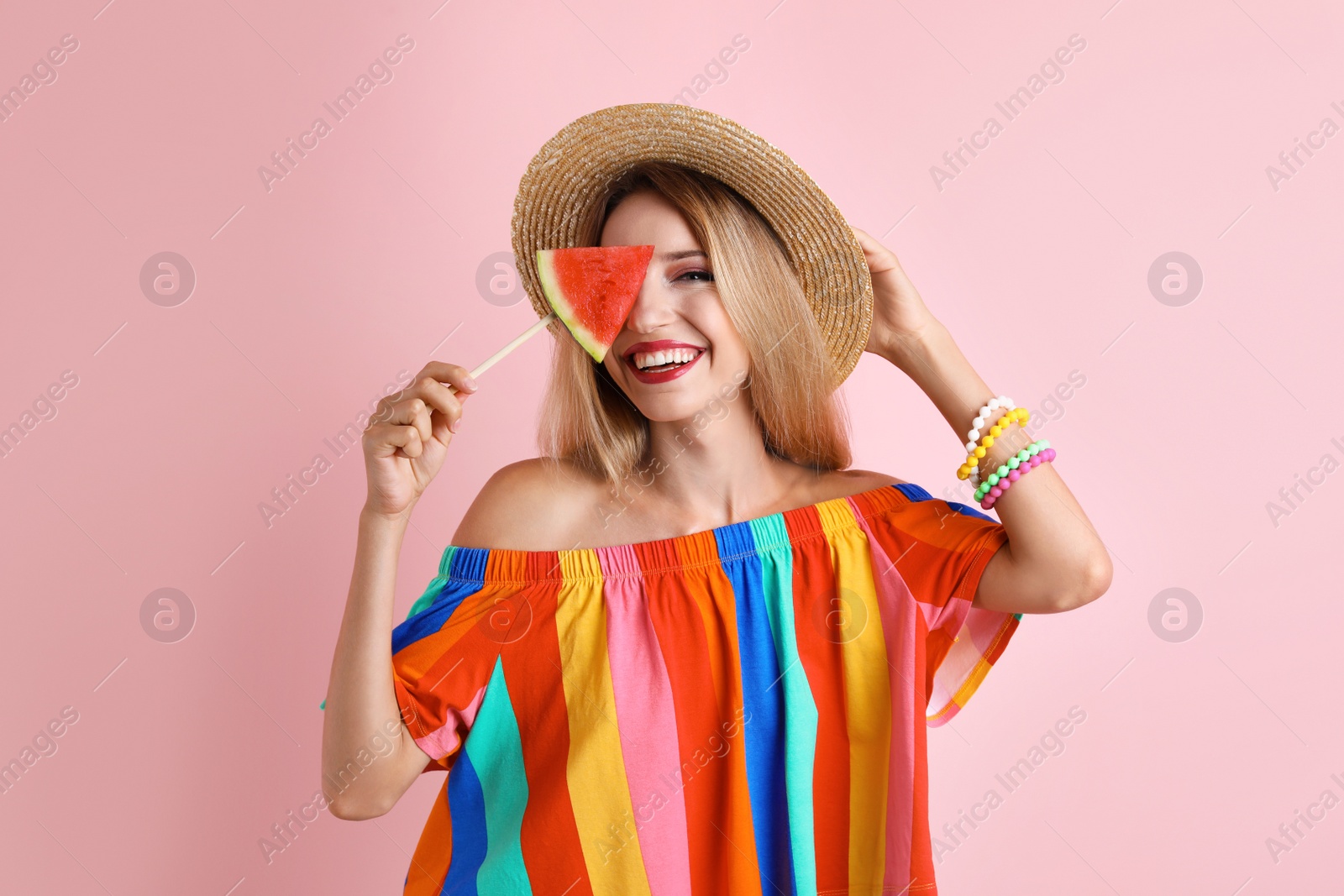 Photo of Pretty young woman with juicy watermelon on color background