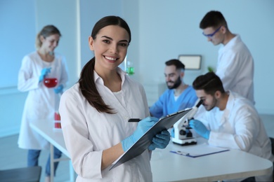 Photo of Medical student with clipboard in modern scientific laboratory
