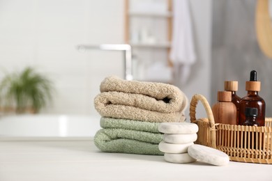 Photo of Composition with spa products on white table in bathroom, space for text