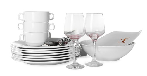 Photo of Many dirty dishes and glasses isolated on white