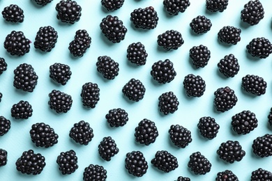 Photo of Tasty ripe blackberries on light blue background, flat lay