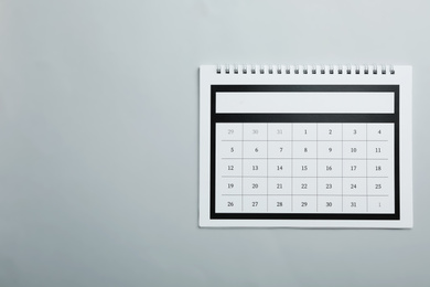Photo of Paper calendar on light grey background, top view. Space for text
