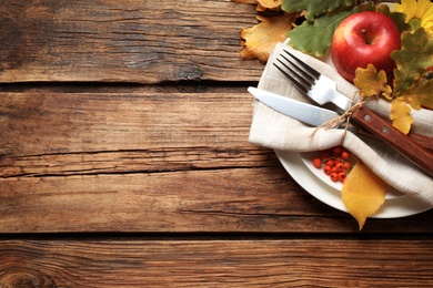 Photo of Festive table setting on wooden background, above view with space for text. Thanksgiving Day celebration