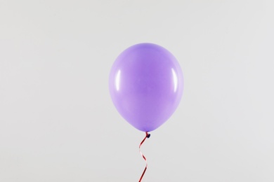 Photo of Bright balloon on light background. Celebration time