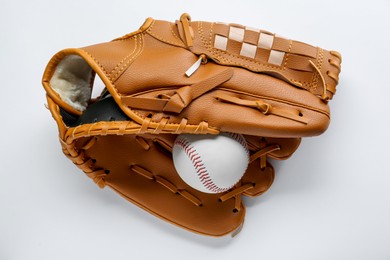 Catcher's mitt and baseball ball on white background, top view. Sports game