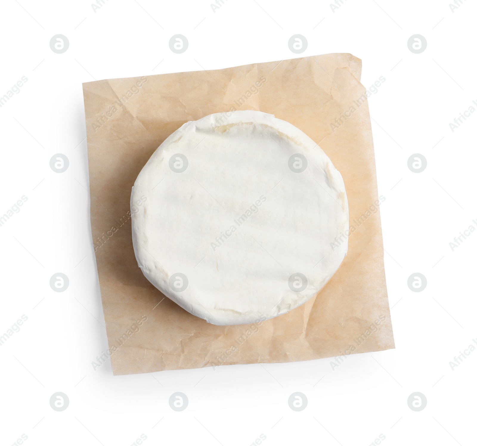 Photo of Parchment with delicious brie cheese isolated on white, top view