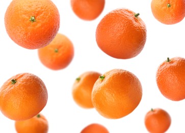 Image of Fresh ripe tangerines falling on white background