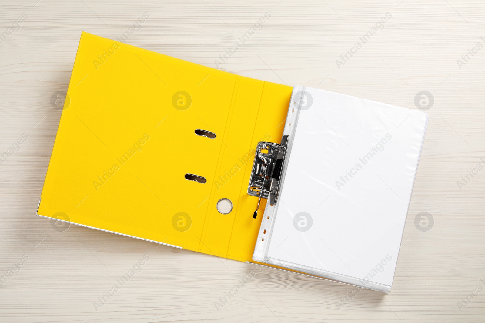 Photo of Open office folder on white wooden table, top view