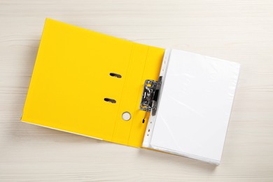 Open office folder on white wooden table, top view