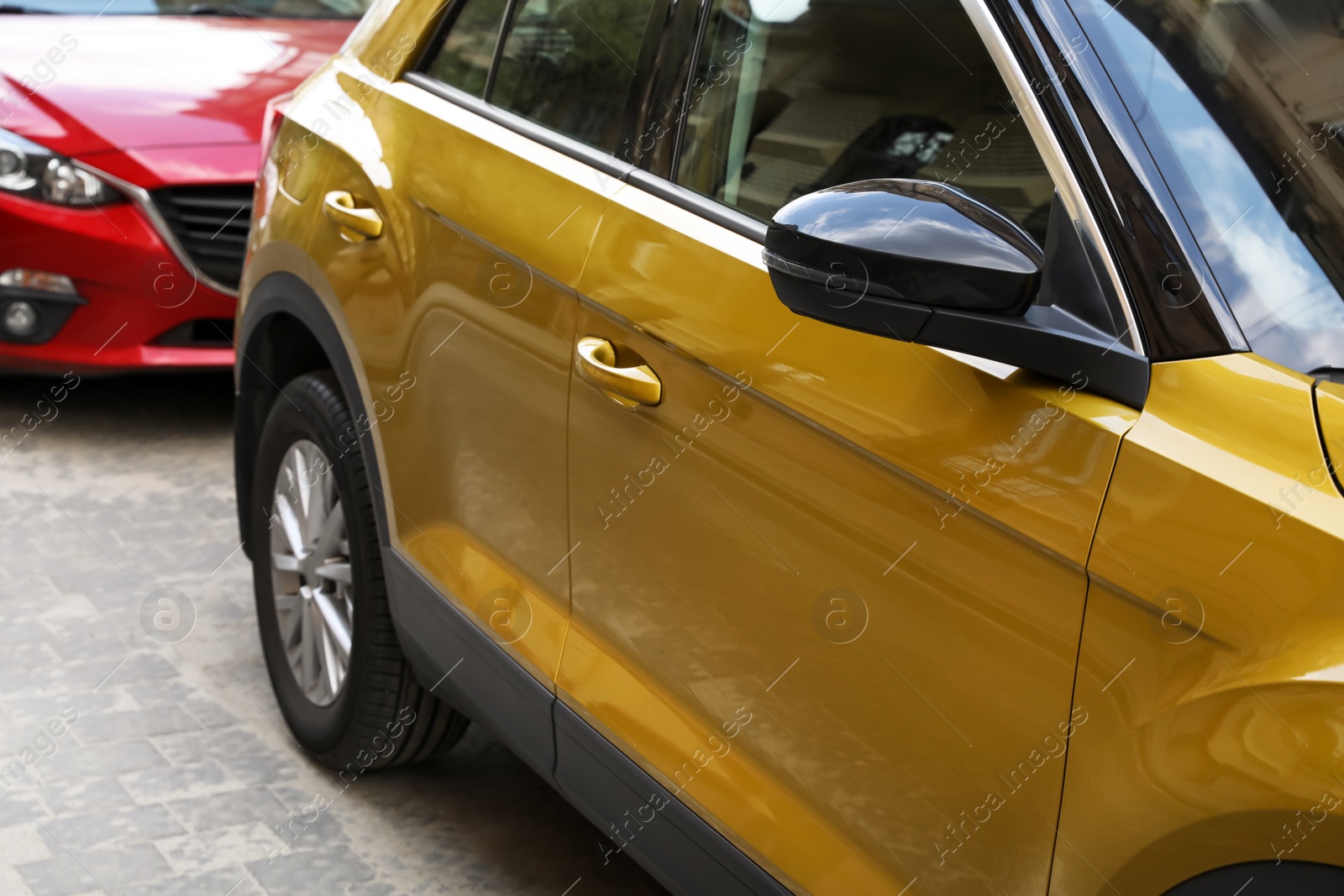 Photo of Colorful cars parked on city street, closeup