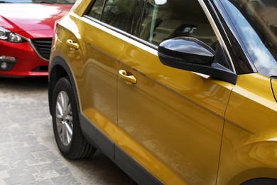 Colorful cars parked on city street, closeup