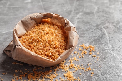 Bag with brown sugar on table