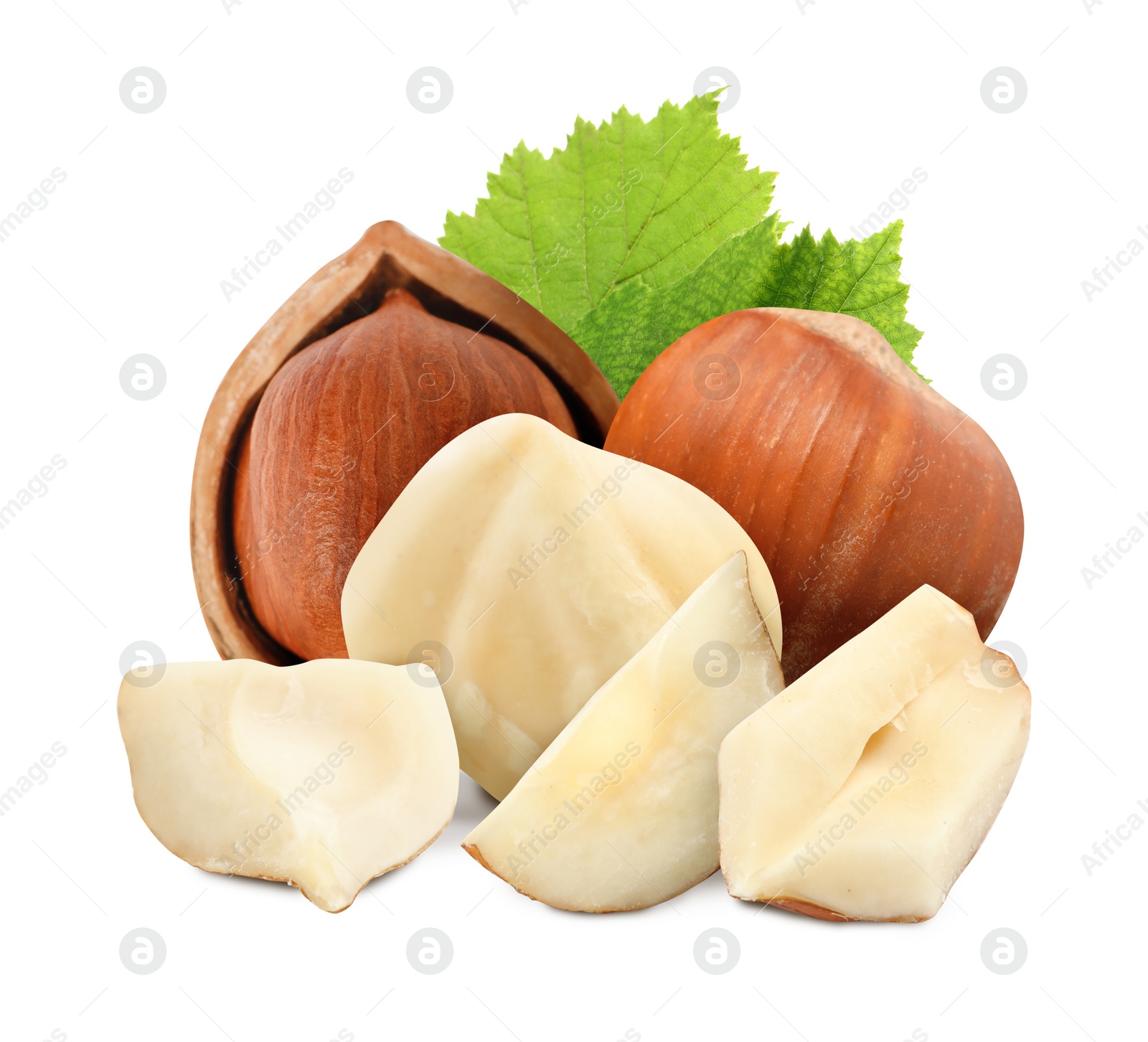 Image of Tasty hazelnuts and green leaves on white background