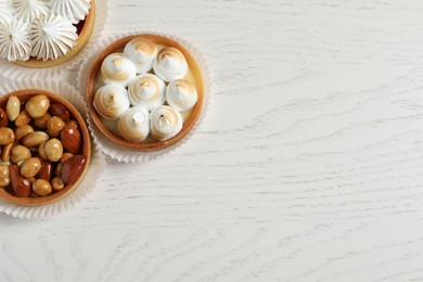 Photo of Different tartlets on white wooden table, flat lay with space for text. Tasty dessert