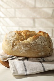 Photo of Freshly baked sourdough bread on white table