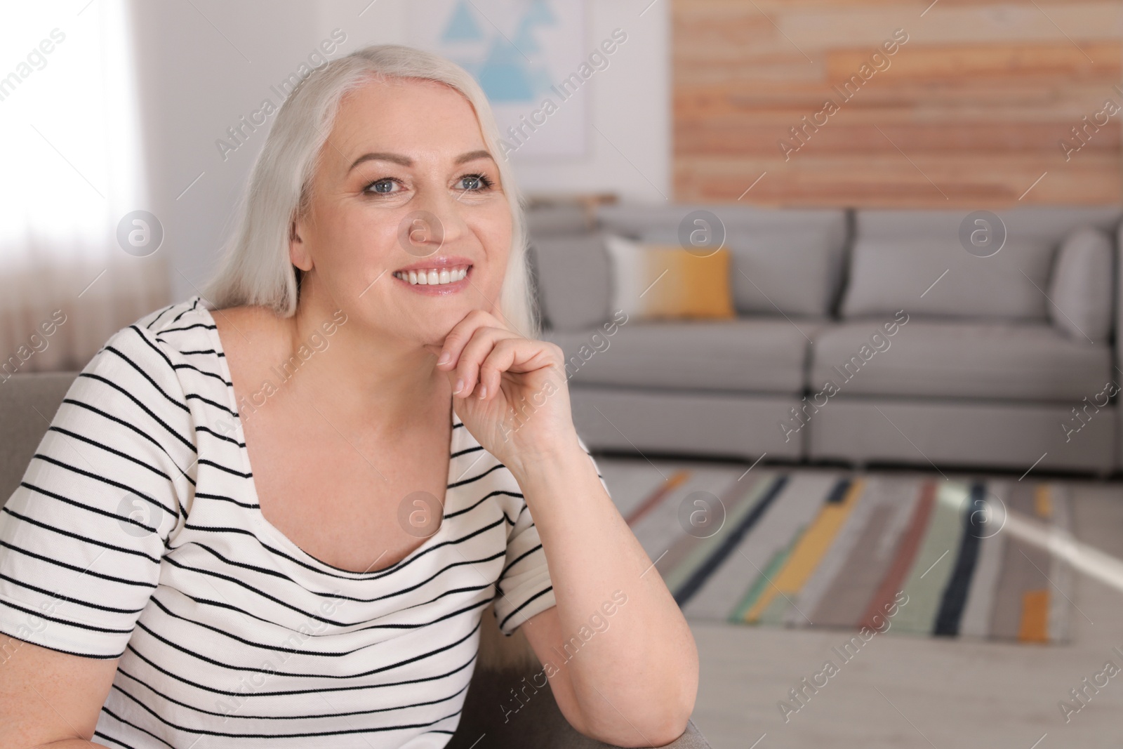 Photo of Portrait of mature woman in living room