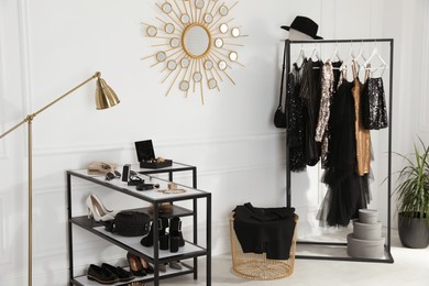 Stylish dressing room interior with trendy clothes, shoes and accessories