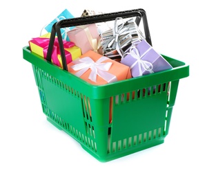 Photo of Green shopping basket with different gifts on white background