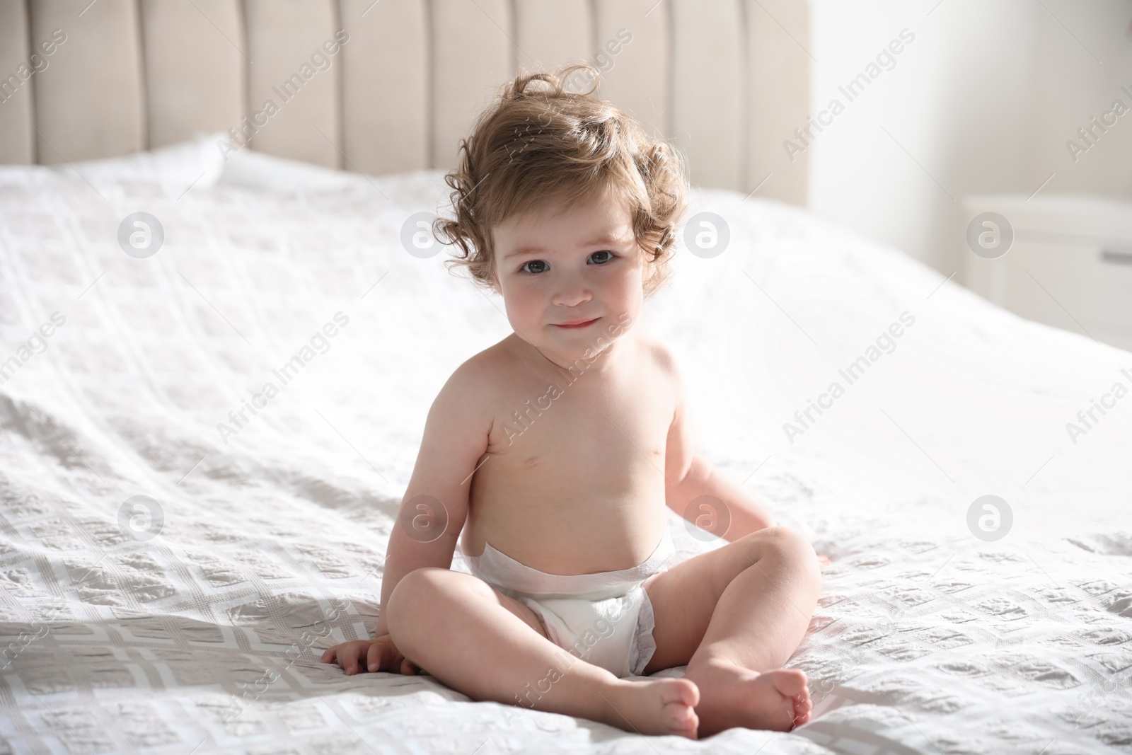 Photo of Cute little baby on bed at home