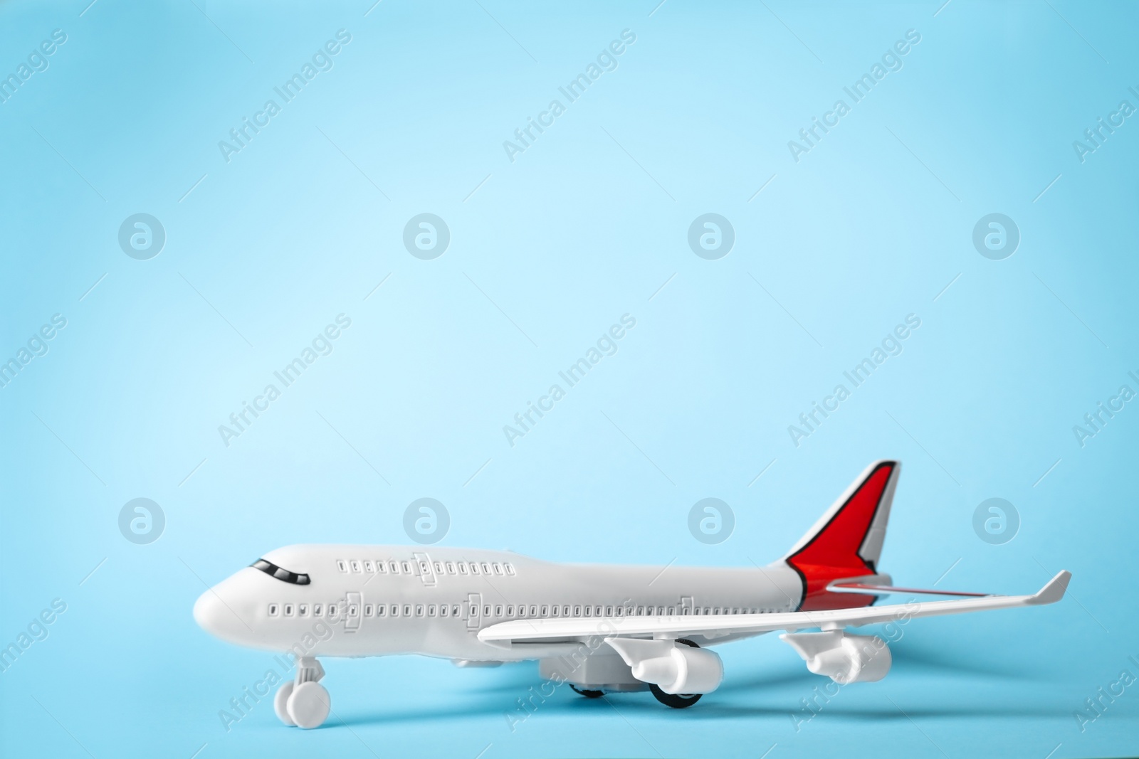 Photo of Toy plane on blue background, space for text. Logistics and wholesale concept