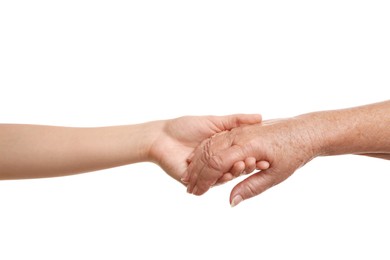 Photo of Young and elderly women holding hands together on white background, closeup