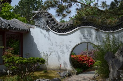 Photo of HAREN, NETHERLANDS - MAY 23, 2022: Beautiful view of Moon gate in Chinese garden