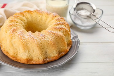 Photo of Delicious freshly baked sponge cake on white wooden table, closeup. Space for text