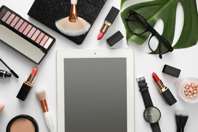Composition with tablet, makeup products and accessories on white background, top view. Fashion blogger
