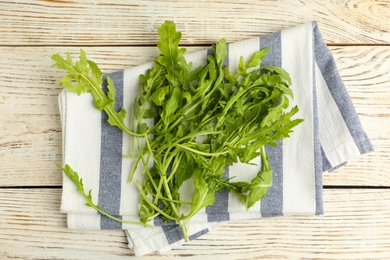 Fresh arugula on white wooden table, flat lay