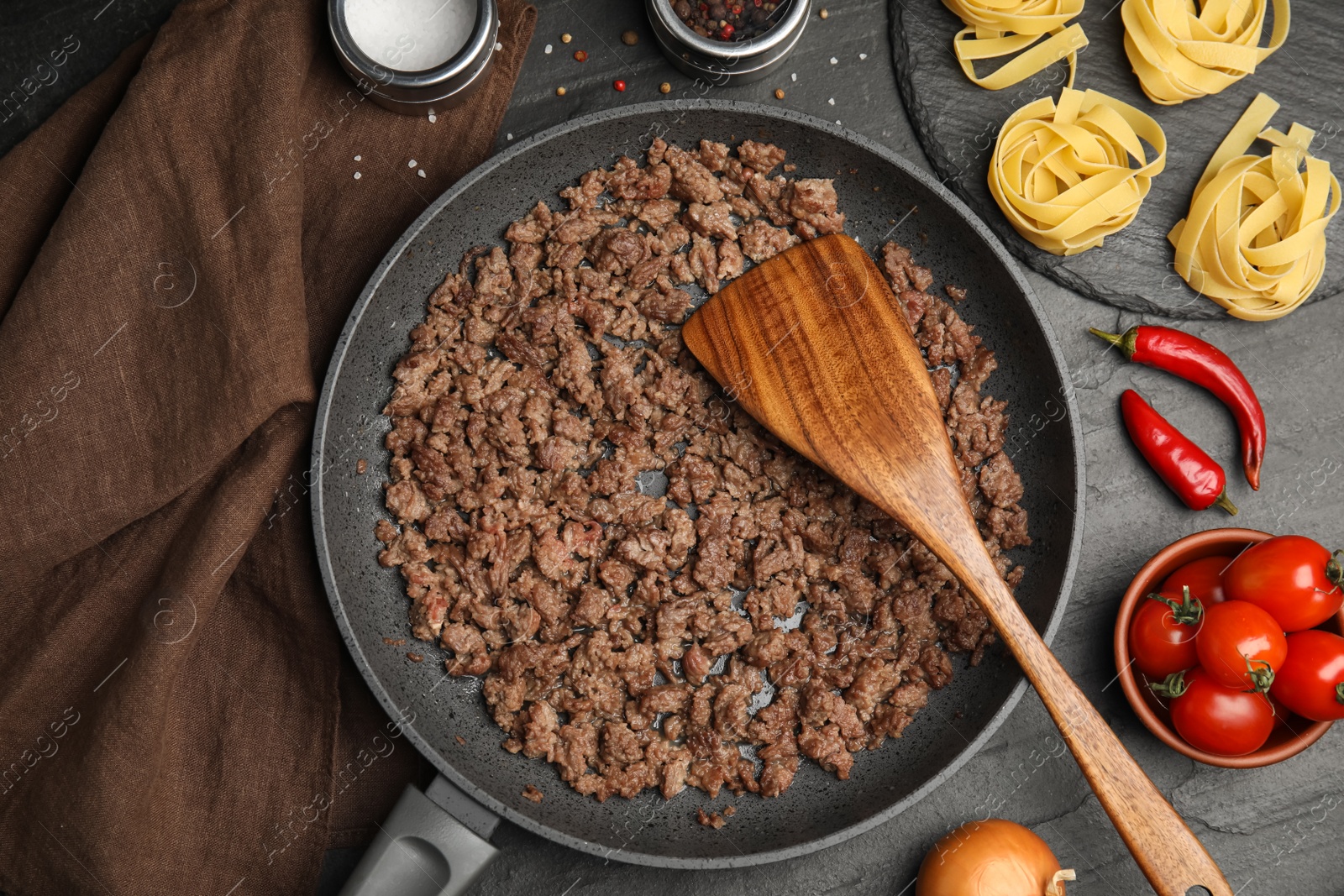 Photo of Fried minced meat served on black table, flat lay