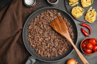 Fried minced meat served on black table, flat lay