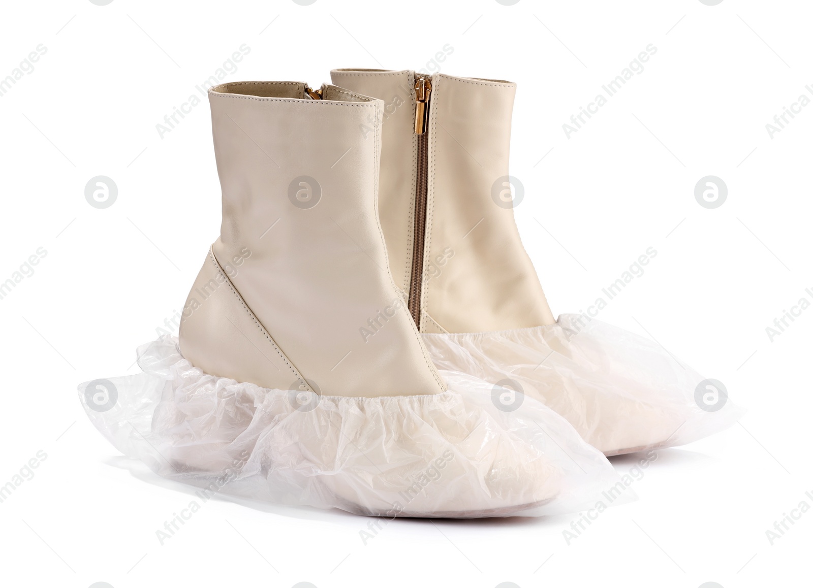 Photo of Women's boots in shoe covers isolated on white