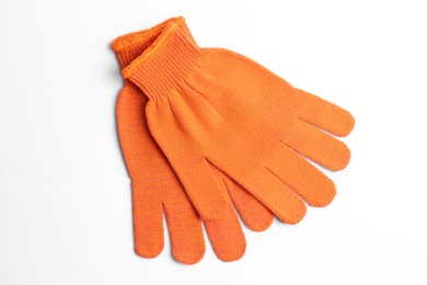 Orange gardening gloves on white background, top view