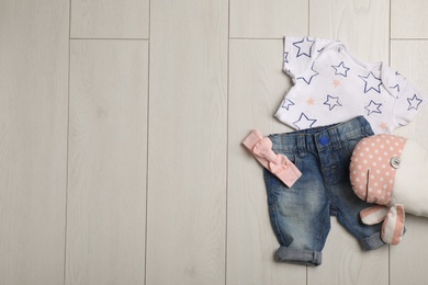 Photo of Flat lay composition with clothes and space for text on wooden background. Baby accessories