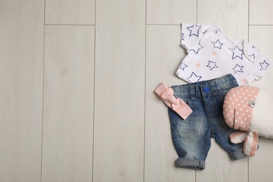 Flat lay composition with clothes and space for text on wooden background. Baby accessories