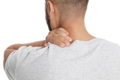 Man suffering from neck pain on white background, closeup