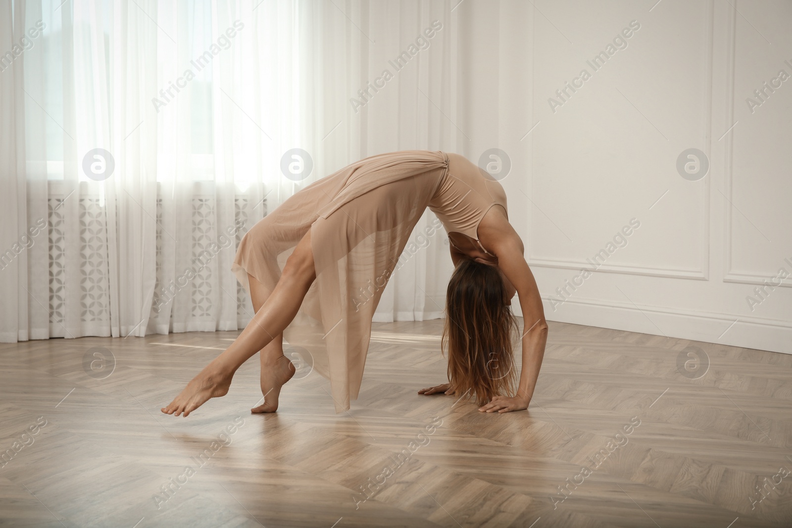 Photo of Beautiful professional dancer practicing moves in studio