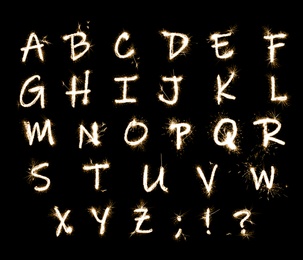 Image of Set with letters made of sparkler on black background