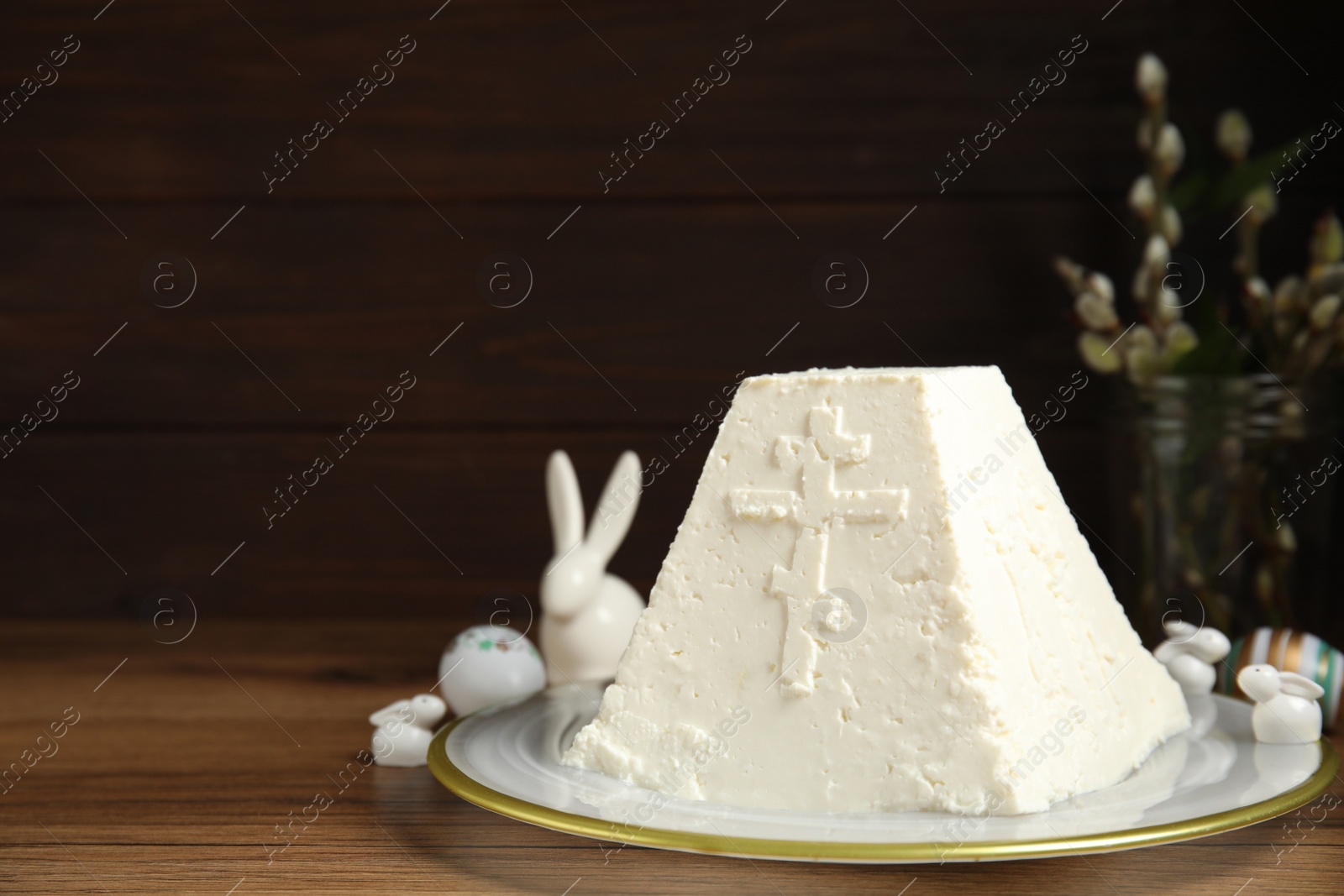 Photo of Traditional cottage cheese Easter paskha on wooden table, space for text