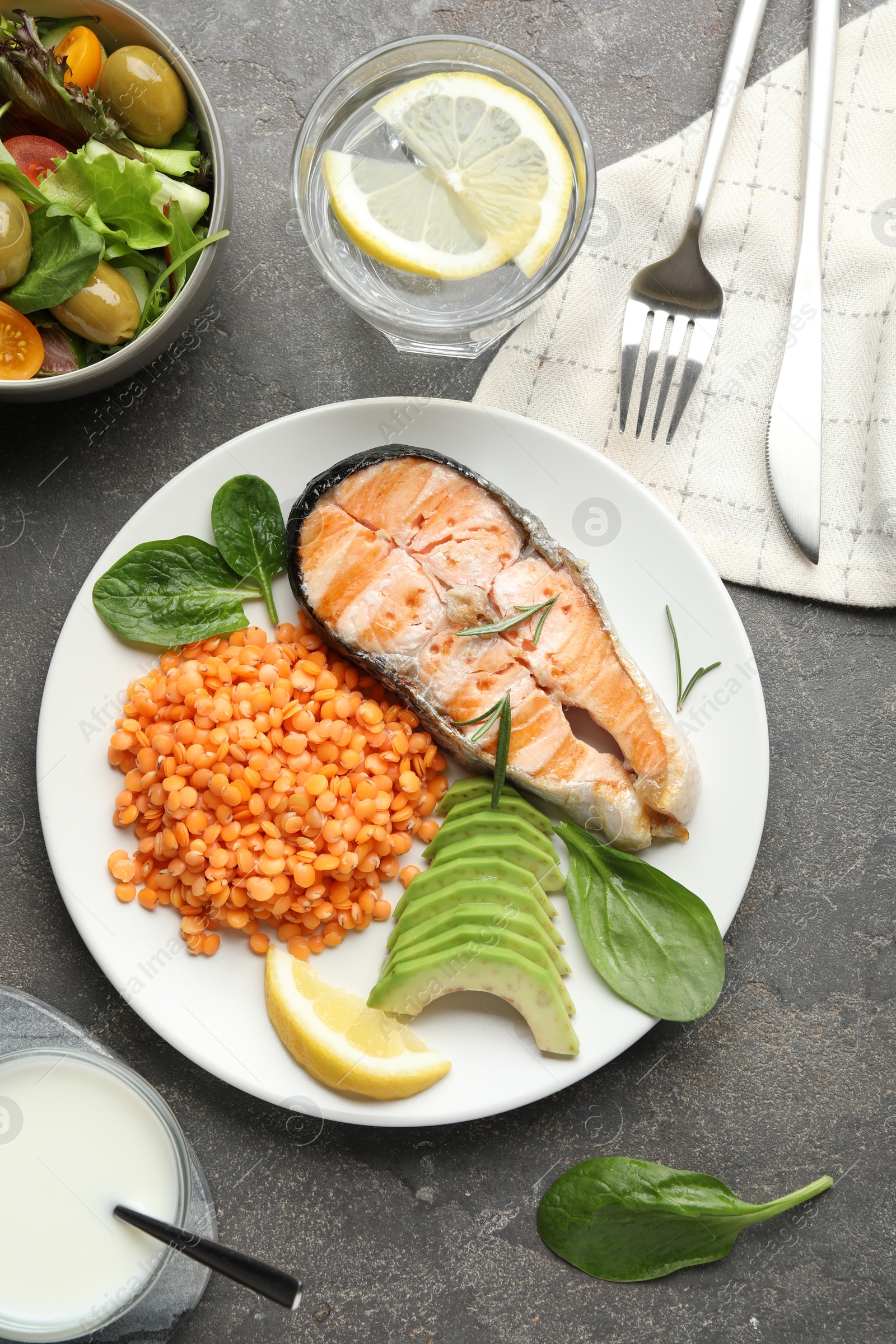 Photo of Healthy food high in vegetable fats served on grey textured table, flat lay