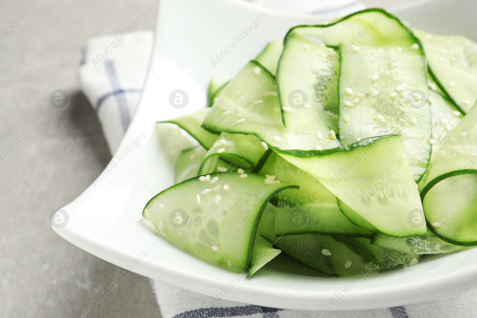 Photo of Plate with delicious cucumber salad on table, closeup